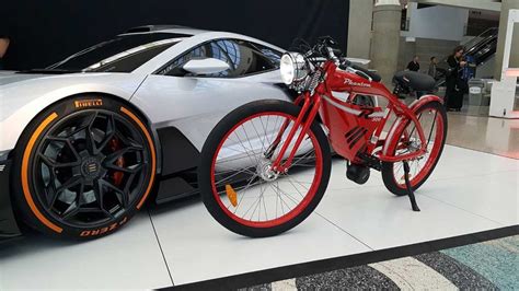 White Lamborghini Aventador Beside Red Phantom R Electric Bike