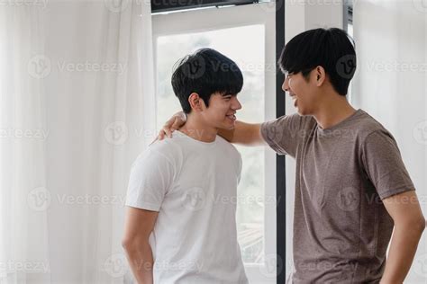 Asian Gay Couple Standing And Hugging Near The Window At Home Young Asian Lgbtq Men Kissing