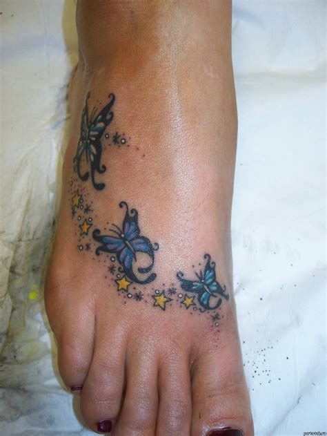 Three Blue Painted Butterflies On Foot Tattoo Tattooimagesbiz