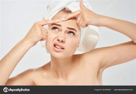 Woman And Squeezes Pimples On Her Face Problem Skin With A Towel On Her