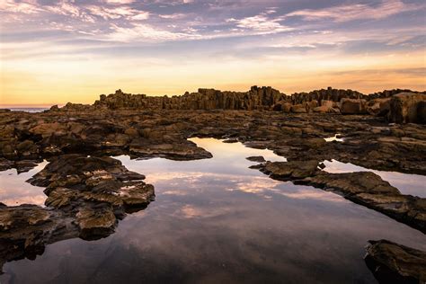 Rocks Calm Body Of Water And Overlooking Mountain Bombo Quarry Image