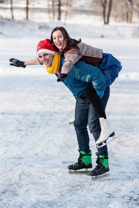 Happy Couple Having Fun Ice Skating On Rink Outdoors Stock Image
