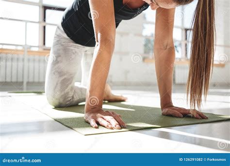 Strong Athletic Woman Doing Stretching Workout On Yoga Mat In Sunny