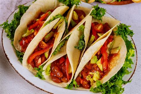 Flour Tortillas Stuffed With Meat Beans And Vegetables On White Plate