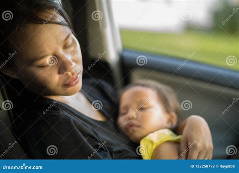 Tired And Exhausted Mother Taking Care Of Her Baby Postpardum