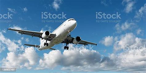 Xl Jet Airplane Landing In Bright Sky Stock Photo Download Image Now