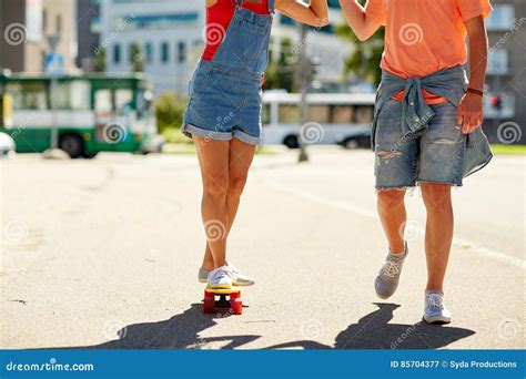 Teenage Couple Riding Skateboard On City Street Stock Image Image Of