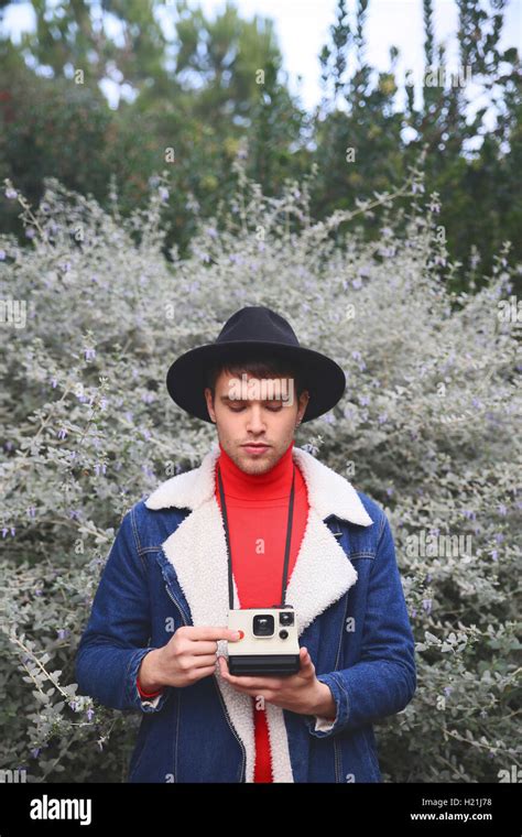 Man Holding Polaroid Camera Outdoors Stock Photo Alamy