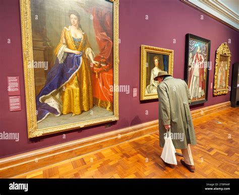 Musuem Visitor Looking At The Historical Paintings Inside The National