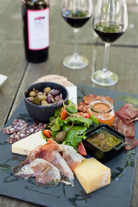 An Assortment Of Food And Wine On A Table
