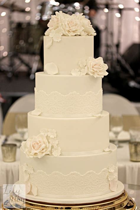 Four Tier Wedding Cake Finished With Handmade Sugarpaste Roses And Cherry