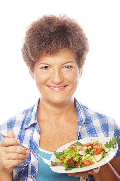 premium photo mature smiling woman eating salad