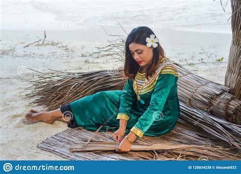Beautiful Maldivian Woman In National Red Dress Making Ropes Editorial