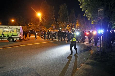 protesters officers clash outside se portland precinct thursday police declare gathering