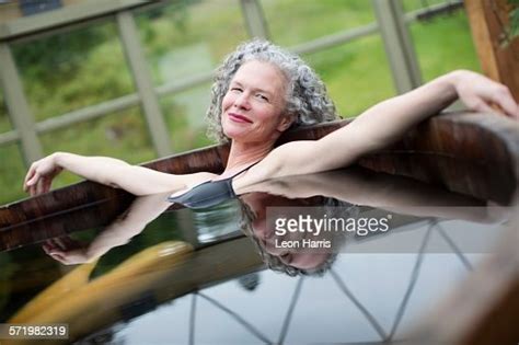 Portrait Of Mature Woman Relaxing In Hot Tub At Eco Retreat High Res