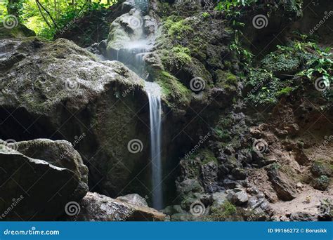 Amazing Rocks Covered With Moss With Flowing Waterfall Stock Photo