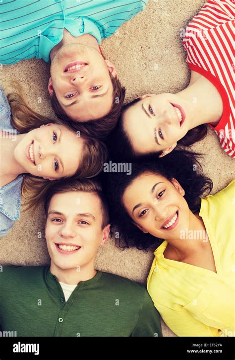 Group Of Smiling People Lying Down On Floor Stock Photo Alamy