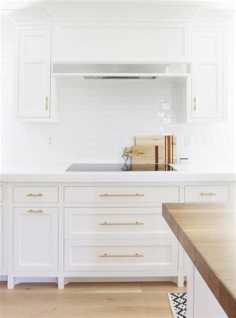 Blue shaker pantry cabinets with brass pulls surround a white farmhouse sink fitted with a brushed gold gooseneck faucet in a pantry off a transitional a striking gold and black modern chandelier illuminates white shaker kitchen cabinets donning brushed gold pulls and a marble countertop fixed. 8 Best Hardware Styles For Shaker Cabinets