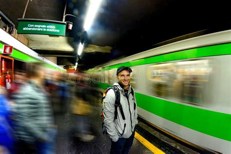 A Man Waits For The Arrival Of A Train At A Subway Station In Milan