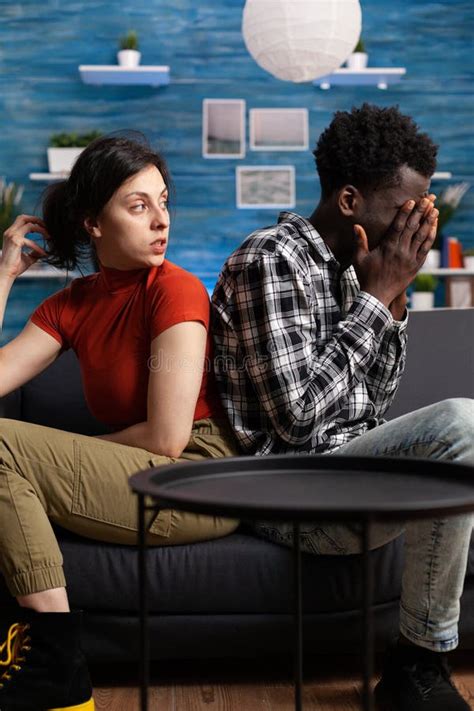 Displeased Interracial Couple Sitting On Sofa In Silence Stock Image Image Of Worried