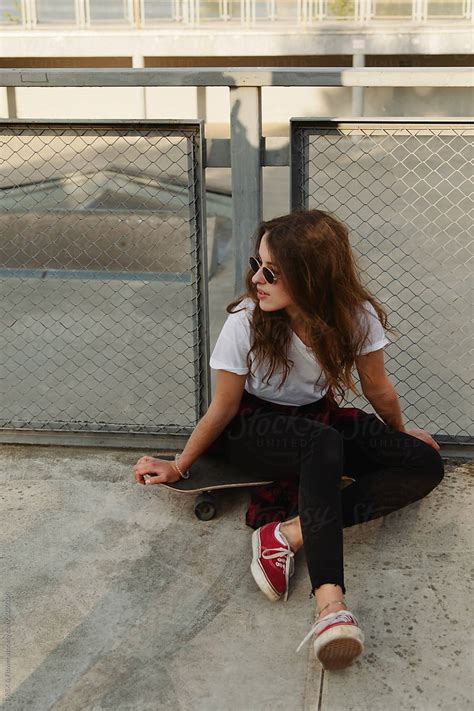 Teenage Girl Sitting On Skateboard Del Colaborador De Stocksy Danil