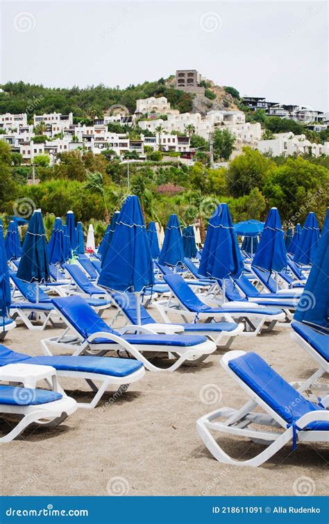 Rows Of Empty Blue Sun Loungers And Umbrellas On The Beach Camel Beach