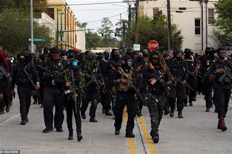 Hundreds Of Members Of An All Black Militia Raise Their Guns During