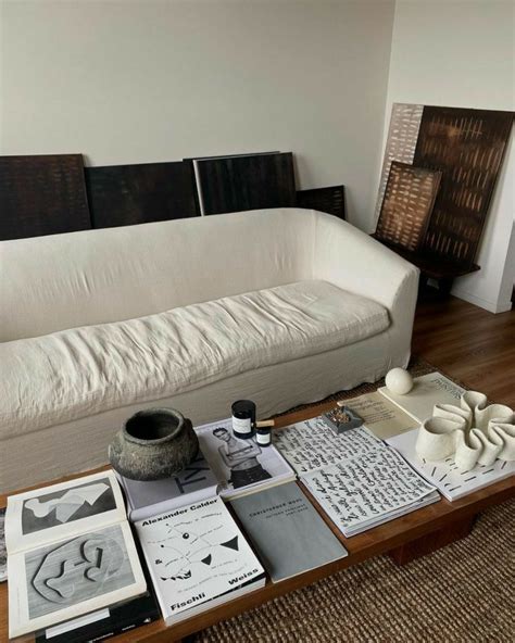 A White Couch Sitting Next To A Wooden Coffee Table