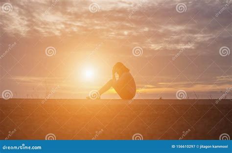 Silhouette Of Lonely Depressed And Sad Woman Cry And Hug Her Knees