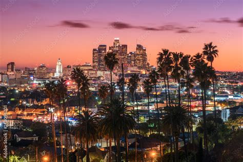 Beautiful Sunset Of Los Angeles Downtown Skyline And Palm Trees In