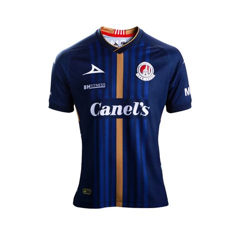 It's dark blue with a gold gradient stripes pattern on the front and more gold trim on the sleeves and back of the collar. 18007 JERSEY VISITANTE ATLETICO SAN LUIS 2020
