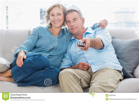 Maybe you would like to learn more about one of these? Happy Couple Cuddling And Sitting On The Couch Watching Tv ...