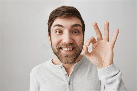 Close Up Portrait Of Funny European Guy Showing Okay Or Fine Sign While