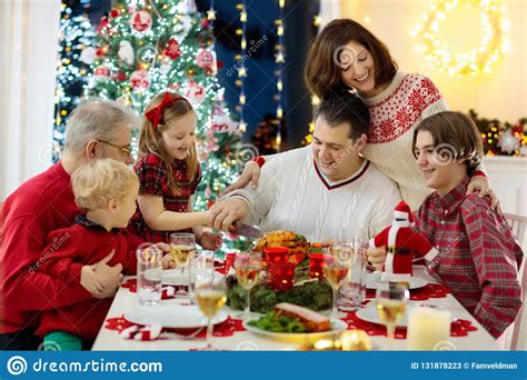 Our festive menu for two makes the most of smaller birds and dainty desserts, so christmas dinner while for many christmas brings a tornado of guests, others prefer to keep things small scale. Family With Kids Having Christmas Dinner At Tree Stock Image - Image of female, daughter: 131878223
