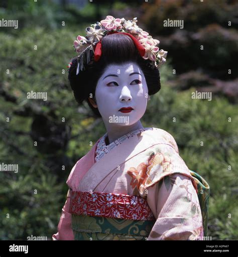 Girl In Maiko Trainee Geisha Costume In Japanese Garden Of Gion Kyoto Wearing Kimono Obi Wig