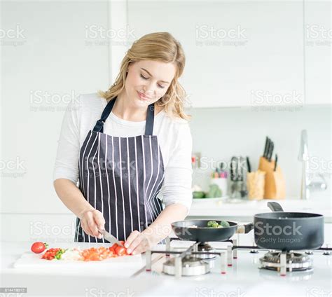 Woman Cooking Dinner At Home Stock Photo Download Image Now Women