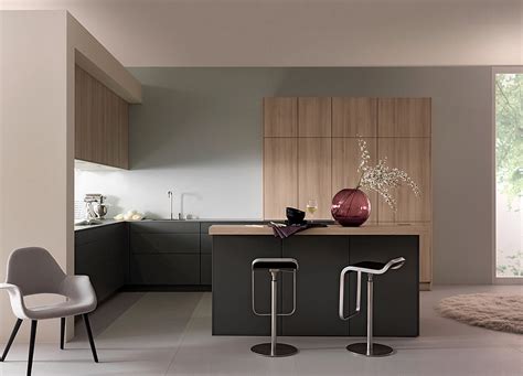 This design is defined by functionality, sleek furniture, mixed materials, and a wide range of colors, from neutral to bold. Sleek modern kitchen in black and light wood tones - Decoist