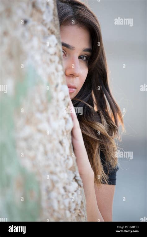 Scaered Young Woman Hiding Behind The Wall Stock Photo Alamy
