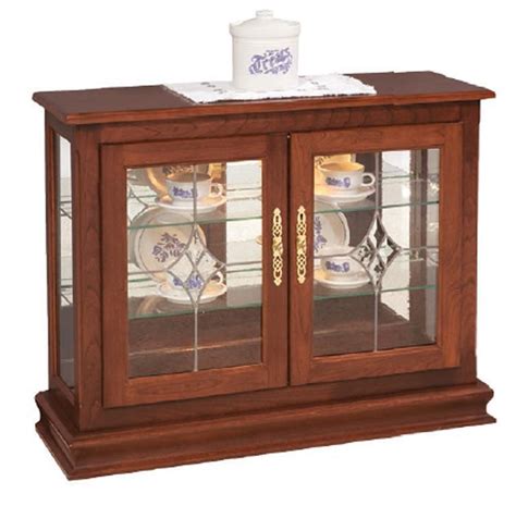 A curio cabinet is a specialised type of display case, made predominantly of glass with a metal or wood framework, for presenting collections of curios, like figurines or other interesting objects that invoke curiosity, and perhaps share a common theme. Small Console Curio Cabinet Display Case from ...
