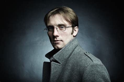 Artistic Dark Portrait Of The Young Beautiful Man In A Gray Coat Stock