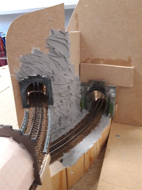 A Model Train Set Is Being Built With Cardboard And Construction