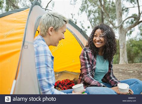 Happy Female Friends Having A Conversation While Camping Stock Photo