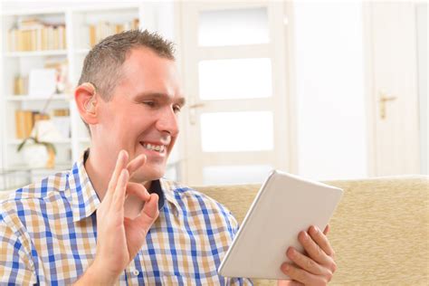 Deaf Man Using Sign Language On The Tablet Telecommunication Access