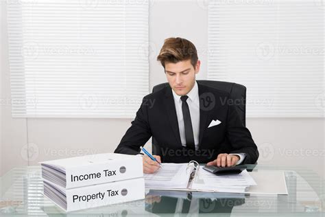 Businessman Calculating Tax In Office 1027267 Stock Photo At Vecteezy