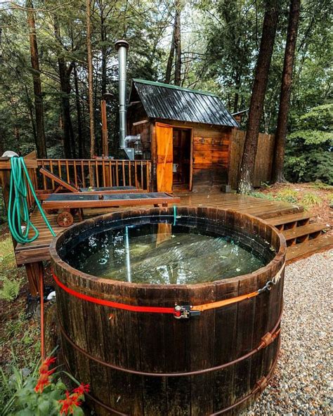 A Wooden Hot Tub Sitting On Top Of A Lush Green Forest