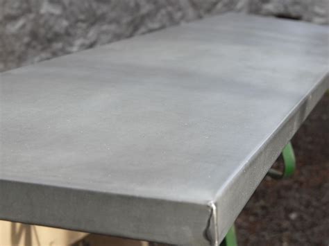 This table has a design inspired by iconic 1950s sleek industrial pieces. aged zinc veneer table top from metaltoppedtables.com ...