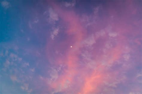 White Moon On Colorful Vivid Pink And Blue Twilight Sky Stock Photo
