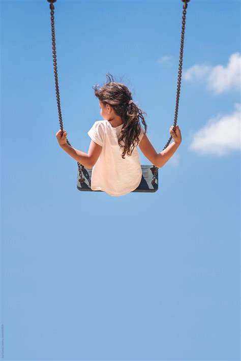 Girl Sitting On A Swing Flying High In The Blue Sky By Lea Csontos