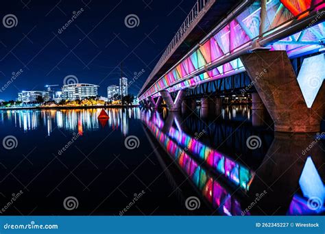 Night Shot Of Tempe Town Lake With The Famous Rainbow Colored Bridge In