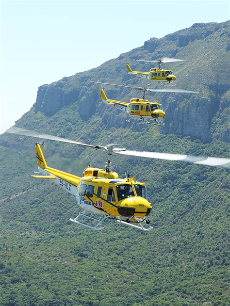 Enca's ronald masinda is on the. Working on Fire Huey Helicopter over Table Mountain in ...